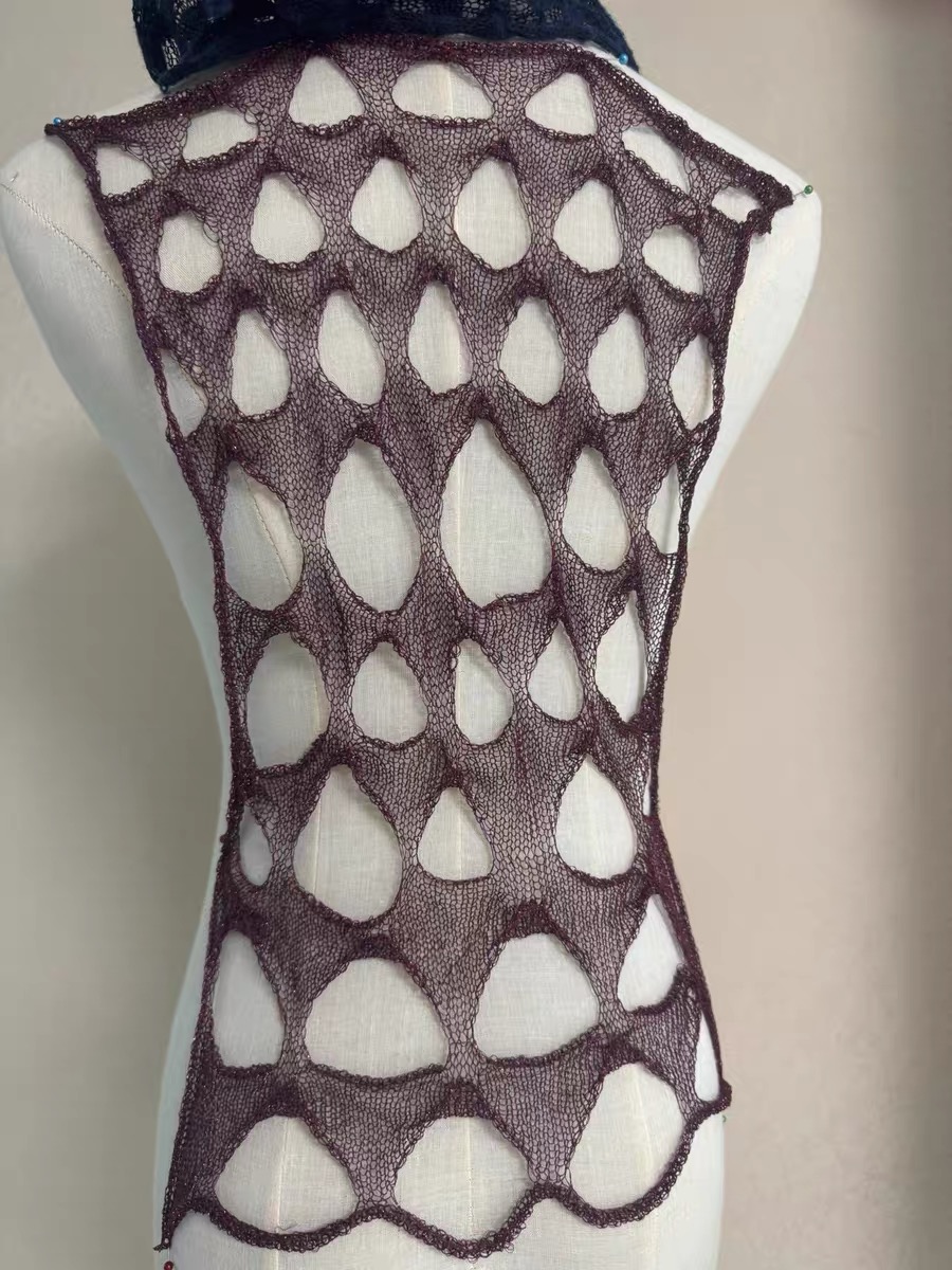 Completed open knitted sample on a mannequin